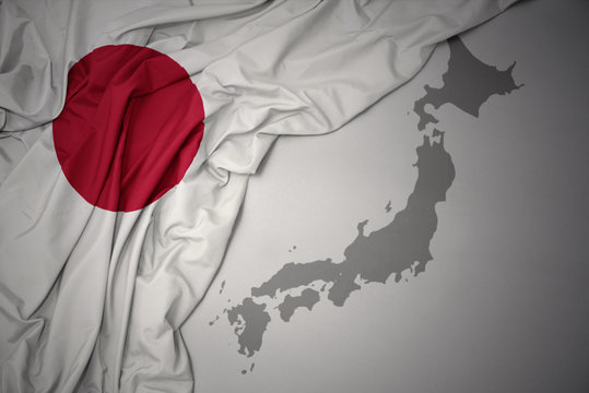 waving colorful national flag and map of japan.