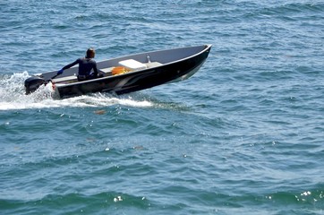 Small black aluminum motor boat primarily used for fishing.