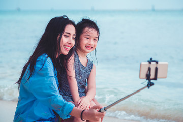Obraz premium happy family selfie at the beach. Focus on the screen of the phone.