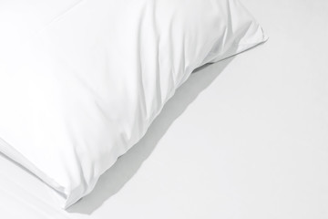 Close up of bedding sheets with copy space,White pillow on the bed with blanket.