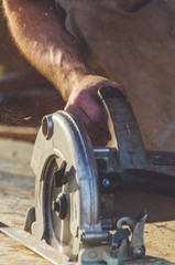 worker cut with electric saw