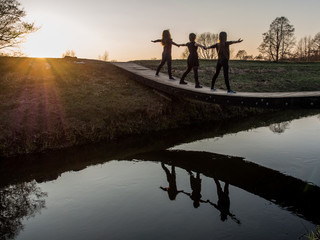 Silhouettes of young girls and their reflection