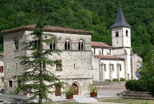 Church and romanesque style house in the village of Burlats near Castres, Tarn, France