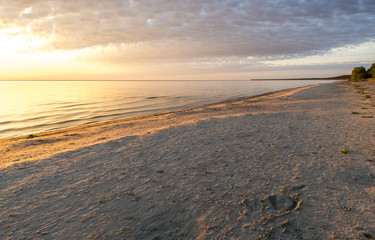 Fototapeta na wymiar Coastal landscape at colorful dawn, sandy beach of the Baltic Sea