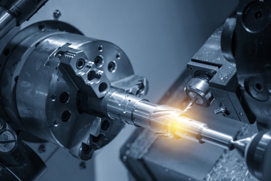 The CNC turning or lathe machine cutting groove slot at the brass shaft  by the milling spindle. Hi - technology manufacturing process.