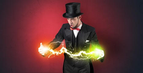 Magician sparkling super power between his two hands