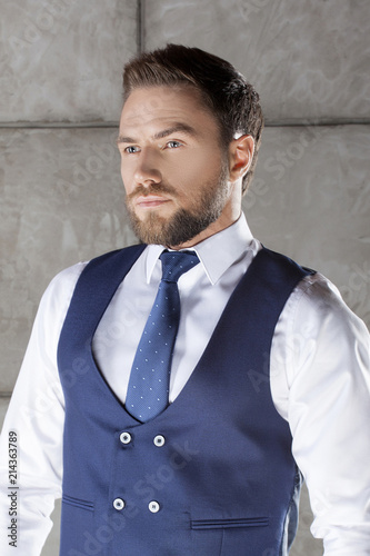 Man With Tie And Bkue Vest Suit Modern Hair Style Beard