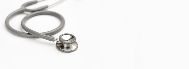 Gray stethoscope medical equipment on white canvas with copy space. instruments device for doctor....