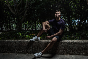 Obraz premium portrait of attractive young man sitting on a step
