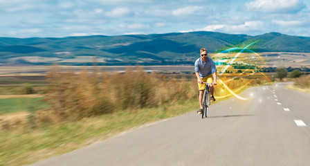 Obraz premium Young cyclist riding bicycle with magical landscape and concept