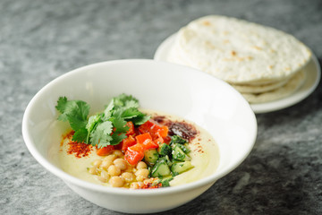 Hummus with vegetables, herbs, spices and cakes