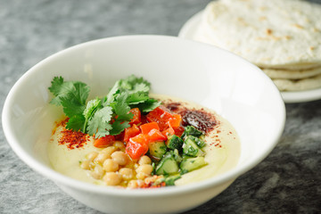 Hummus with vegetables, herbs, spices and cakes