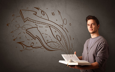 Casual young man holding book with brown arrows and stars flying out of it