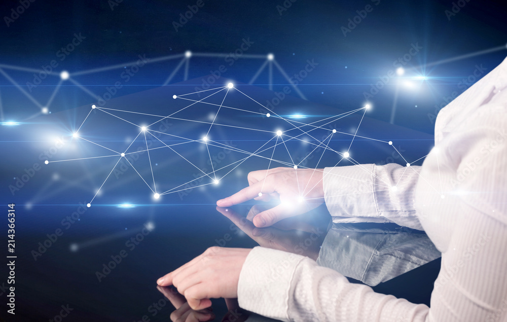 Poster male hands touching interactive table with blue connectivity graphic in the background