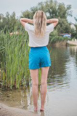 Nature, summer holidays, vacation and people concept - young woman dreaming about good life and enjoy the moment  