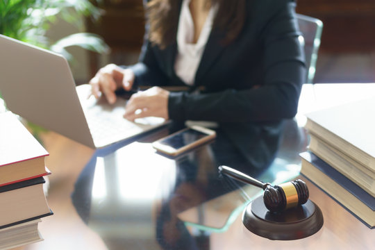 Lawyer Office. Judge Gavel And Lawyer Working On A Laptop With Books And Smartphone. Legal Law, Advice And Justice Concept. Selective Focus