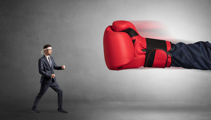 Little man fighting with a giant red boxing glove
