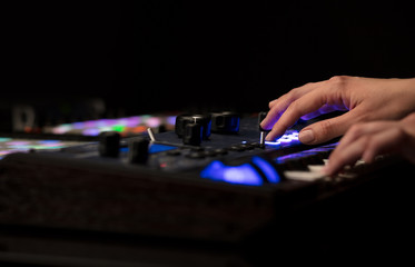 Dj hand remixing music on midi controller
