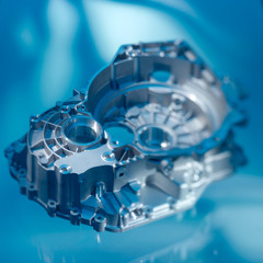 car gearbox housing on blue background, isolated
