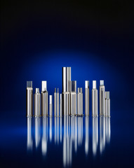 decorative arrangement of punching tools on a black mirror background