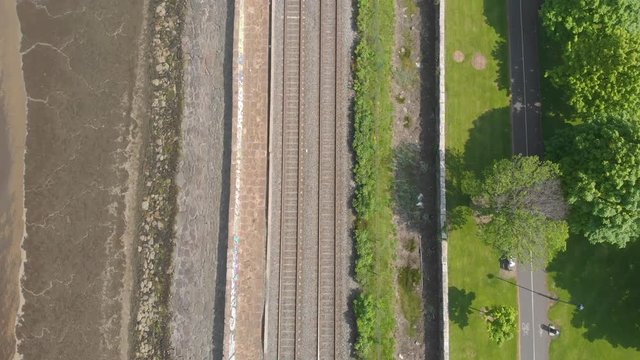 Empty train tracks near bike cycling path at the park, blackrock park, dublin, ireland