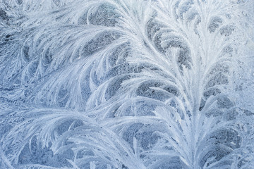 Frosty glass ice background, natural beautiful snowflakes. Frost ice pattern. Winter Christmas abstract backdrop.