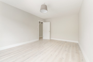Empty bright room with a ceiling lamp