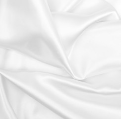 Smooth elegant white silk or satin luxury cloth texture as wedding background. Luxurious background design