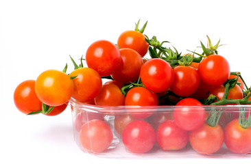 Cherry tomatoes on a branch in transparent retail plastic box