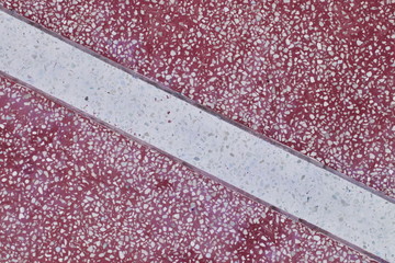 Fototapeta premium Pattern of artificial marble tabletop for background. Red surface with white stripes