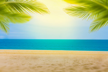 Fototapeta na wymiar Sandy beach with coconut trees and bokeh beach tropical background, summer vacation and travel ideas, relaxation