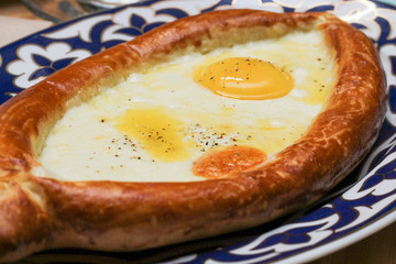 Adjarian khachapuri. Open the bread pie with cheese and egg. Traditional Georgian cuisine.