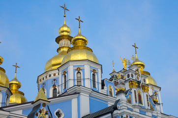 Fototapeta na wymiar Blue Orthodox Church with golden rooftops