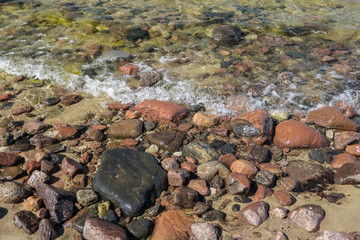 rocky sea beach with waves and sunny day