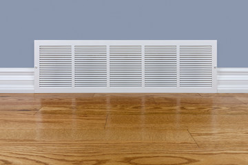 Wall cold air return grille sitting on hardwood floor