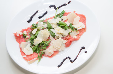 Beef carpaccio with parmesan, rocket and balsamic vinegar