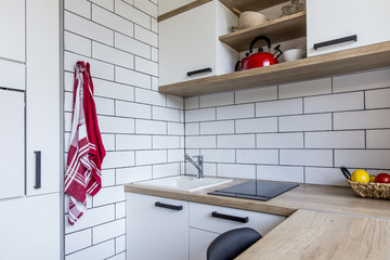 Small tiny white kitchen in panel house in the Czech Republic after the reconstruction with white...