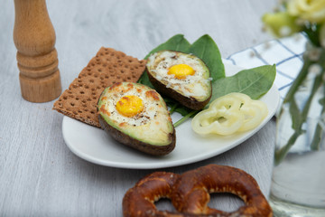 Eggs baked in avocado on plate