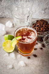 Espresso Tonic, refreshment summer drink with tonic water, lime and coffee, grey stone table, copy...