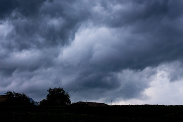 Naklejka na ściany i meble Landscape with a dark stormy sky before a thunderstorm_