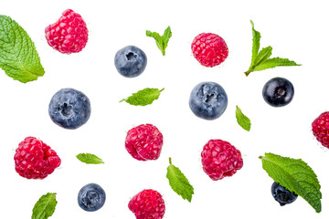 Creative layout, background, with fresh berries, simple pattern on white background. Raspberry, blueberry, mint leaves, slices of lemon.