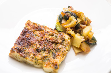 fried fish in the plate with vegetable