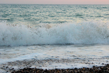 Beach and small waves in the sea, sea foam, as a background