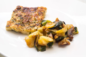 fried fish in the plate with vegetable