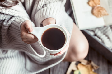 Girl with a cup of coffee in hands