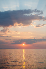 Naklejka na ściany i meble Sunrise over the sea with dramatic sky