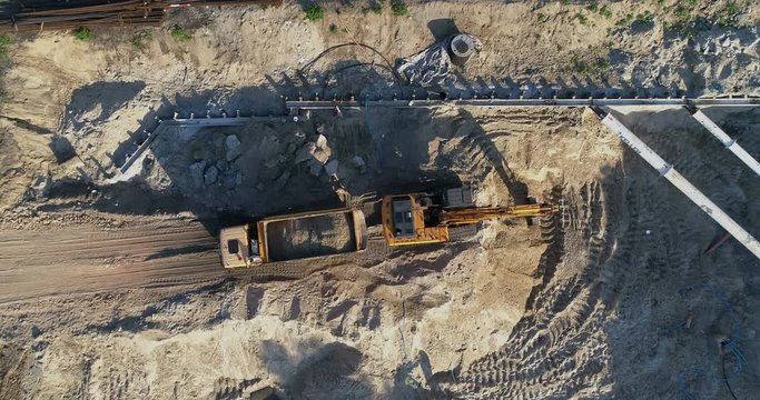 Aerial view of an excavator working on a modern construction site