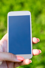 Woman touching a screen of her smarthone 