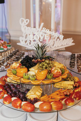 delicious fresh fruits on plate on table at wedding reception in restaurant. luxury catering