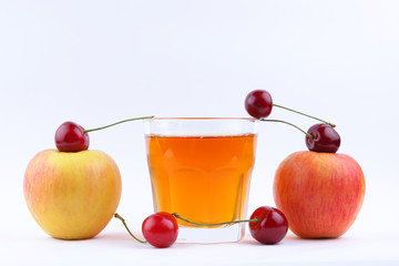 Fresh juice with apples and cherries, fresh apple juice on white background, healthy lifestyle, vegetarian drink, red berries with other fruits